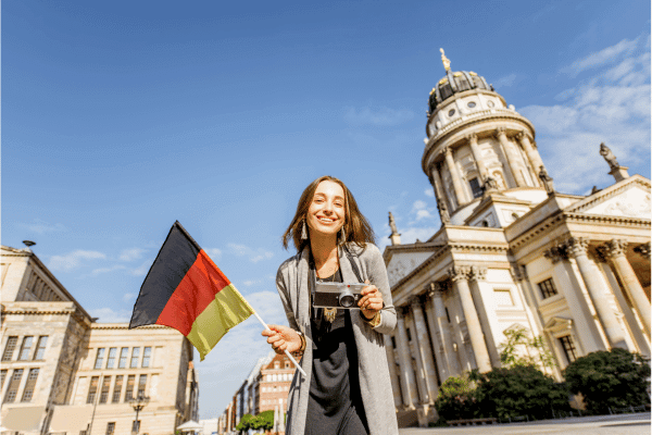 Organisatrice voyage Allemagne - voyageuse avec drapeau allemand lors d'un city-trip à Berlin